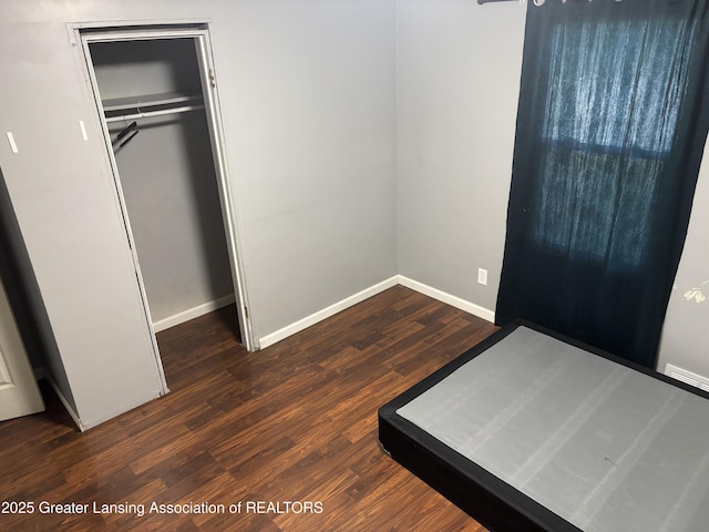 1311 W Saginaw St, East Lansing, MI 48823 - unfurnished bedroom with wood finished floors and a closet