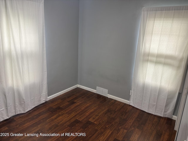 1311 W Saginaw St, East Lansing, MI 48823 - spare room with dark wood-style flooring and baseboards