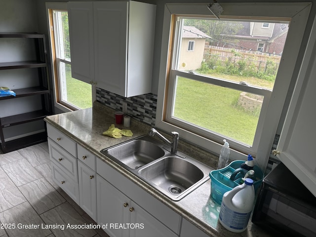 1311 W Saginaw St, East Lansing, MI 48823 - kitchen featuring plenty of natural light and white cabinets