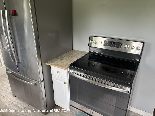 1311 W Saginaw St, East Lansing, MI 48823 - kitchen with stainless steel appliances and white cabinets