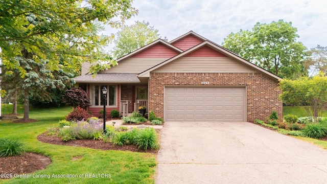 3522 Apple Valley Rd, Okemos, MI 48864 - view of front of house featuring brick siding, a front lawn, concrete driveway, and a garage