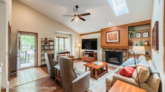 3522 Apple Valley Rd, Okemos, MI 48864 - living area with ceiling fan, a fireplace, wood finished floors, a skylight, and recessed lighting