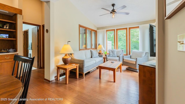 3522 Apple Valley Rd, Okemos, MI 48864 - living area with vaulted ceiling, a ceiling fan, and light wood-style flooring