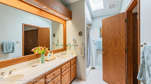 3522 Apple Valley Rd, Okemos, MI 48864 - full bathroom with double vanity, a skylight, tile patterned flooring, and a shower with shower curtain