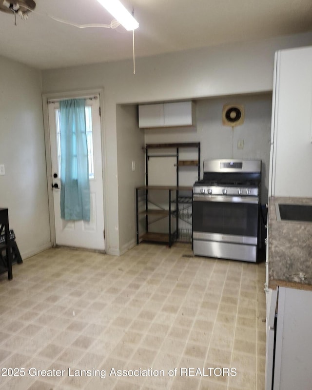 1517 Hyland St, Lansing, MI 48915 - kitchen with stainless steel gas range oven and dark countertops