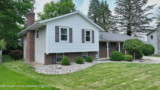6916 Toboggan Ln, Lansing, MI 48917 - tri-level home with a chimney, a front yard, and brick siding