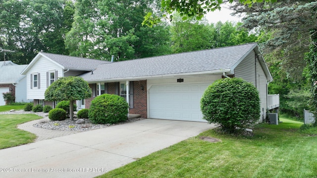 6916 Toboggan Ln, Lansing, MI 48917 - tri-level home featuring an attached garage, a front yard, driveway, and brick siding