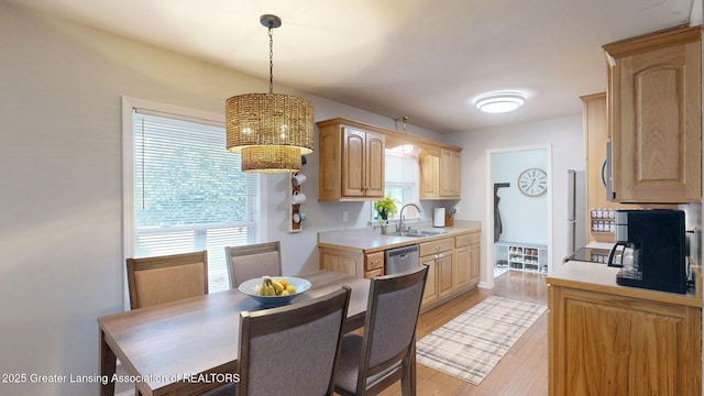 6916 Toboggan Ln, Lansing, MI 48917 - kitchen featuring light countertops, light brown cabinets, a chandelier, and stainless steel appliances