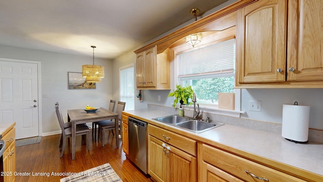 6916 Toboggan Ln, Lansing, MI 48917 - kitchen with stainless steel dishwasher, light countertops, dark wood finished floors, decorative light fixtures, and light brown cabinets