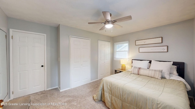 6916 Toboggan Ln, Lansing, MI 48917 - bedroom featuring multiple closets, light colored carpet, and ceiling fan