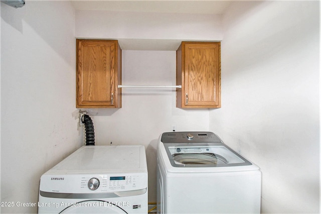6093 Anchor Cv, Dimondale, MI 48821 - washroom with cabinet space and separate washer and dryer