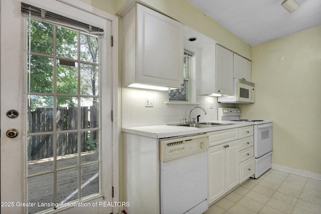 6213 Beechfield Dr, Lansing, MI 48911 - kitchen featuring white appliances, tasteful backsplash, light countertops, and white cabinetry
