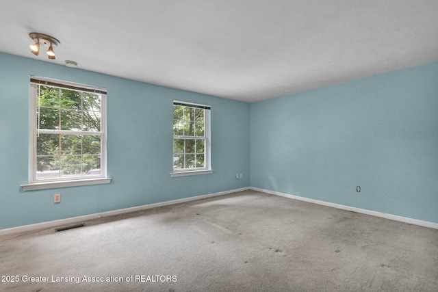 6213 Beechfield Dr, Lansing, MI 48911 - carpeted empty room with baseboards