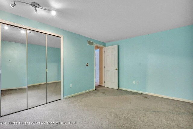 6213 Beechfield Dr, Lansing, MI 48911 - unfurnished bedroom featuring carpet and a closet