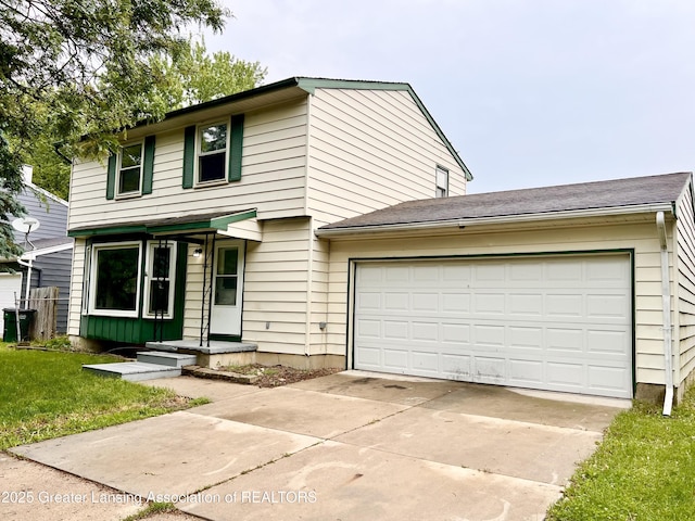 5401 Catalpa Dr, Lansing, MI 48911 - view of front of property featuring a garage, concrete driveway, and a front yard