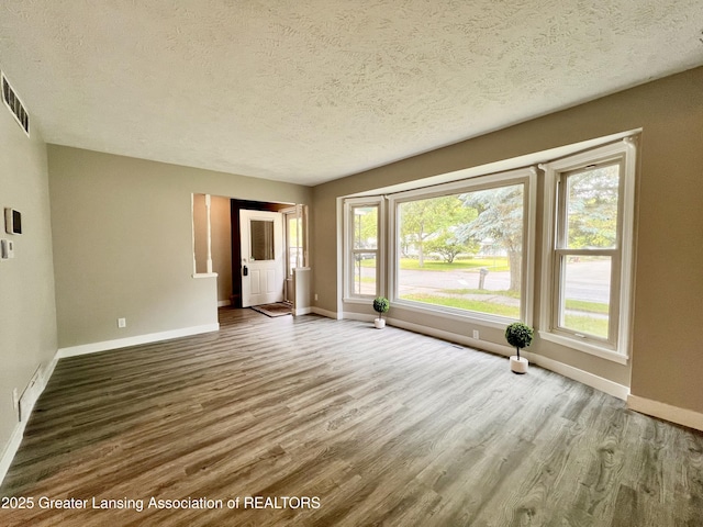 5401 Catalpa Dr, Lansing, MI 48911 - unfurnished room featuring a textured ceiling and wood finished floors
