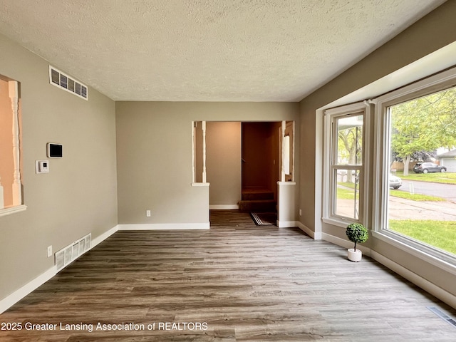 5401 Catalpa Dr, Lansing, MI 48911 - unfurnished room with a textured ceiling and wood finished floors