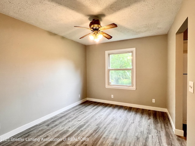 5401 Catalpa Dr, Lansing, MI 48911 - unfurnished room featuring wood finished floors, a ceiling fan, and a textured ceiling