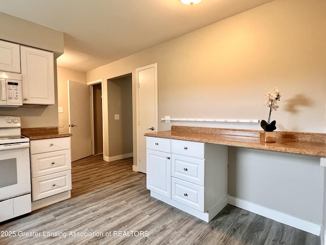 5401 Catalpa Dr, Lansing, MI 48911 - kitchen featuring white appliances, white cabinets, light wood-style floors, and built in desk