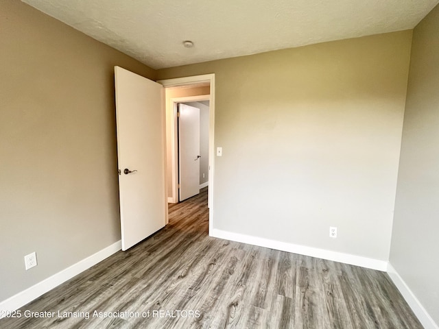 5401 Catalpa Dr, Lansing, MI 48911 - unfurnished room featuring wood finished floors and baseboards