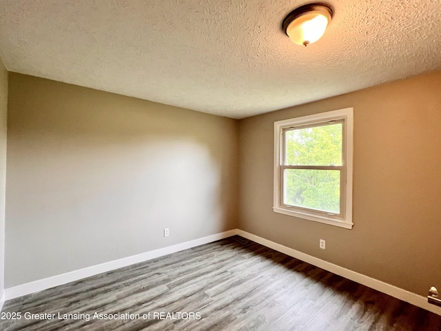 5401 Catalpa Dr, Lansing, MI 48911 - unfurnished room featuring wood finished floors and a textured ceiling