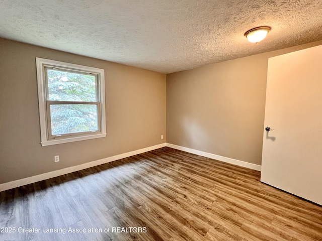 5401 Catalpa Dr, Lansing, MI 48911 - unfurnished room with wood finished floors and a textured ceiling