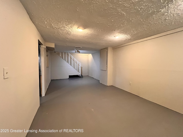 5401 Catalpa Dr, Lansing, MI 48911 - finished below grade area featuring a textured ceiling and stairway