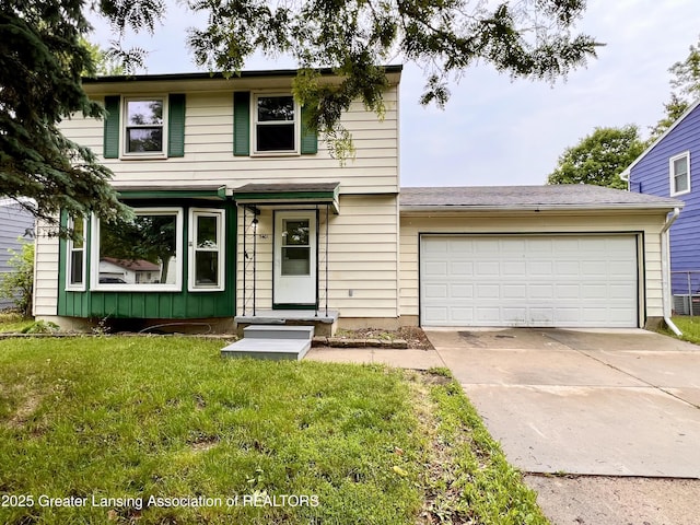 5401 Catalpa Dr, Lansing, MI 48911 - view of front facade with an attached garage, driveway, and a front yard