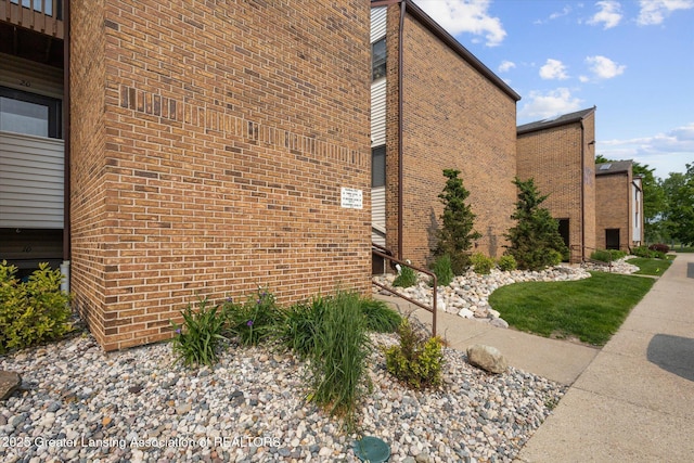 1457 E Pond Dr Unit 21, Okemos, MI 48864 - view of side of home featuring brick siding