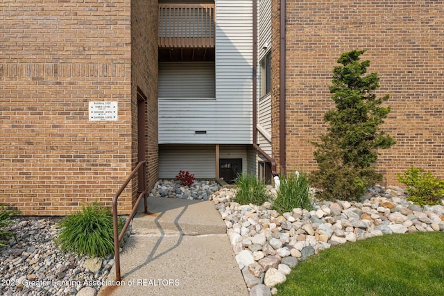 1457 E Pond Dr Unit 21, Okemos, MI 48864 - view of exterior entry with brick siding