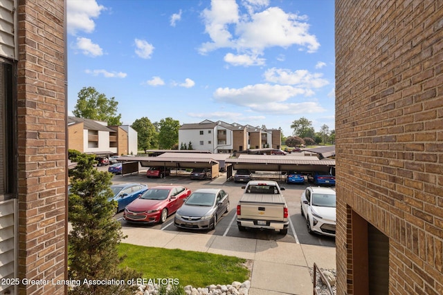 1457 E Pond Dr Unit 21, Okemos, MI 48864 - partially covered parking lot with a residential view