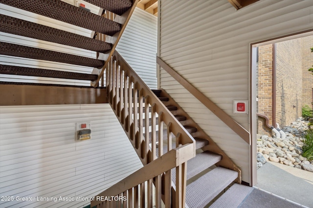 1457 E Pond Dr Unit 21, Okemos, MI 48864 - staircase featuring carpet flooring