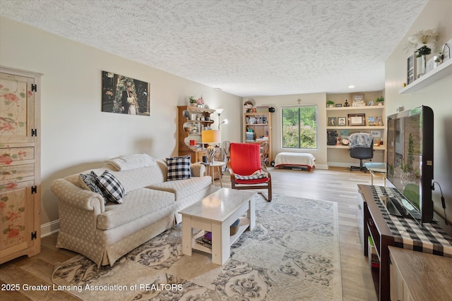 1457 E Pond Dr Unit 21, Okemos, MI 48864 - living room with a textured ceiling and wood finished floors