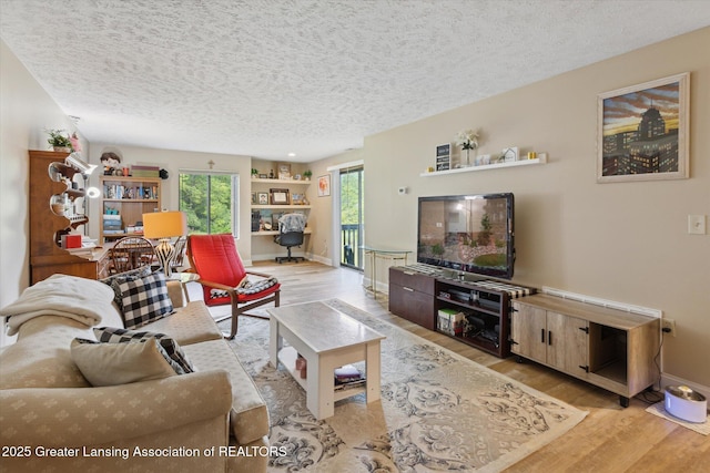 1457 E Pond Dr Unit 21, Okemos, MI 48864 - living area featuring a textured ceiling and wood finished floors