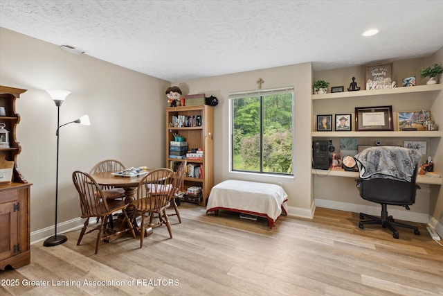 1457 E Pond Dr Unit 21, Okemos, MI 48864 - bedroom featuring light wood-style flooring, a textured ceiling, an office area, and recessed lighting