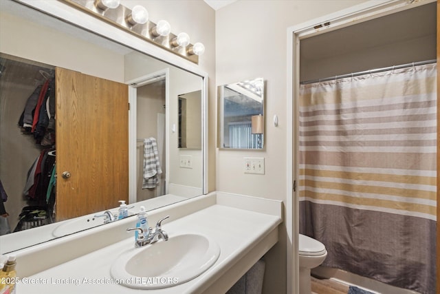 1457 E Pond Dr Unit 21, Okemos, MI 48864 - bathroom with vanity, wood finished floors, and a shower with shower curtain