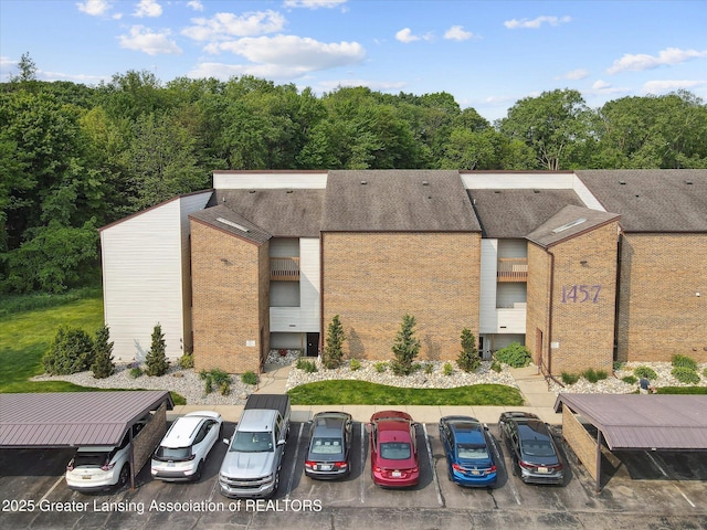 1457 E Pond Dr Unit 21, Okemos, MI 48864 - view of property featuring uncovered parking