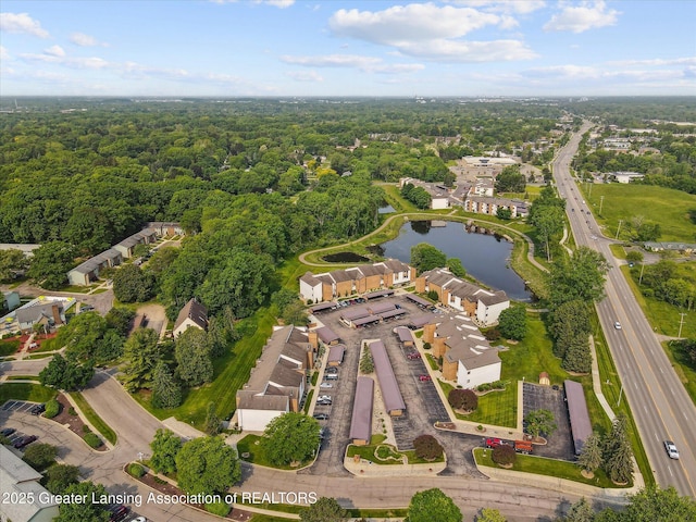 1457 E Pond Dr Unit 21, Okemos, MI 48864 - drone / aerial view of a nearby body of water and a forest