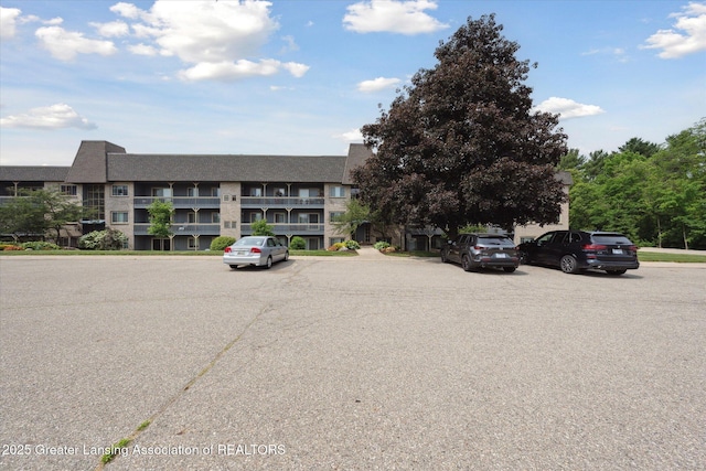 2926 Mount Hope Rd Unit 105, Okemos, MI 48864 - view of building exterior with uncovered parking