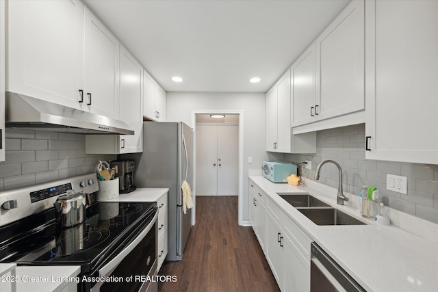 2926 Mount Hope Rd Unit 105, Okemos, MI 48864 - kitchen with appliances with stainless steel finishes, exhaust hood, dark wood-style flooring, white cabinets, and recessed lighting