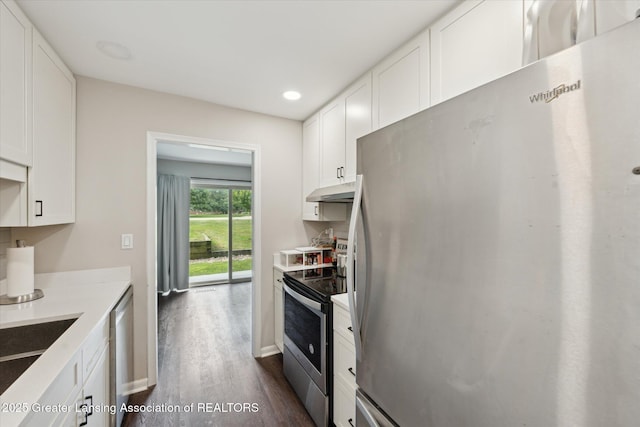 2926 Mount Hope Rd Unit 105, Okemos, MI 48864 - kitchen featuring appliances with stainless steel finishes, dark wood-style floors, under cabinet range hood, white cabinets, and light countertops