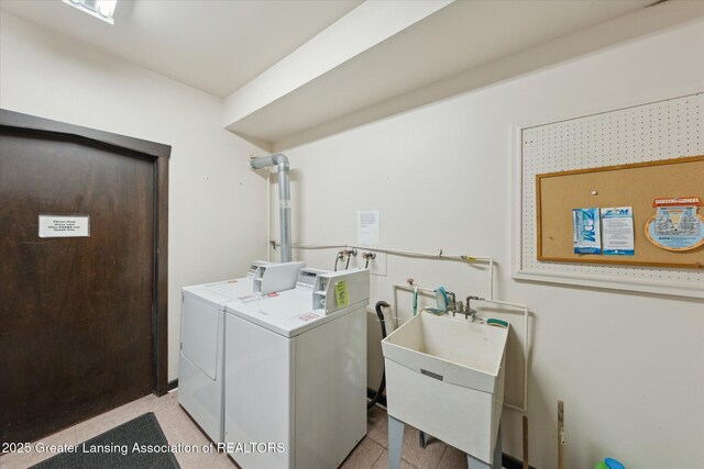 2926 Mount Hope Rd Unit 105, Okemos, MI 48864 - washroom featuring separate washer and dryer and a sink