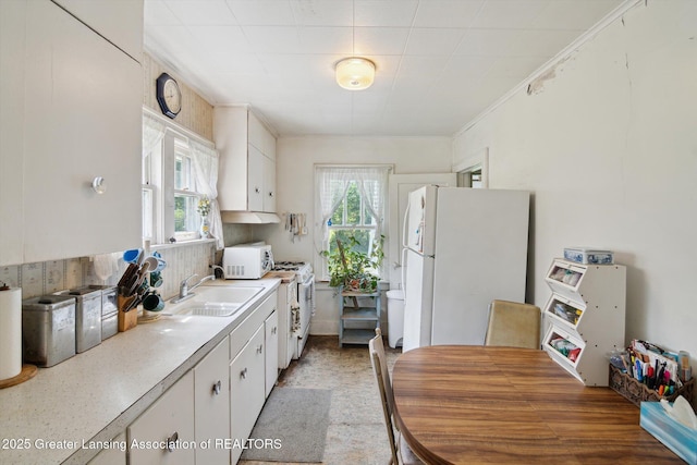 1213 N Woodworth Rd, Jackson, MI 49202 - kitchen featuring white appliances, healthy amount of natural light, and white cabinetry