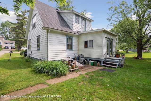1213 N Woodworth Rd, Jackson, MI 49202 - back of property featuring roof with shingles and a yard