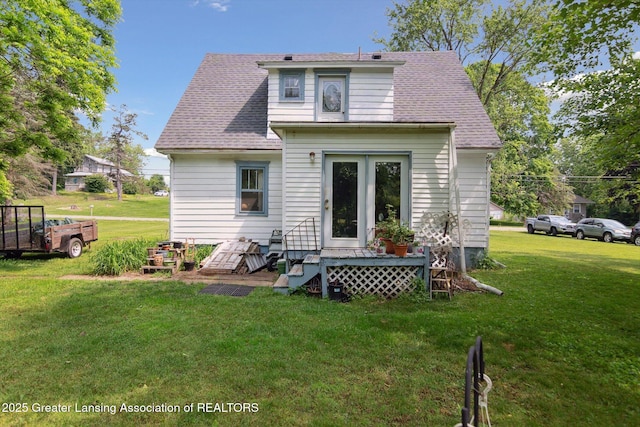 1213 N Woodworth Rd, Jackson, MI 49202 - back of property featuring a yard and a shingled roof