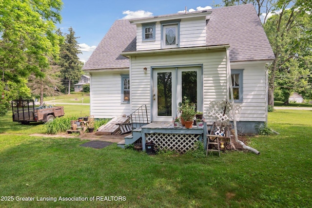 1213 N Woodworth Rd, Jackson, MI 49202 - rear view of property featuring a yard and roof with shingles
