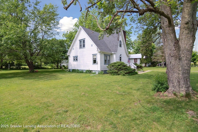 1213 N Woodworth Rd, Jackson, MI 49202 - view of home's exterior with a yard and roof with shingles