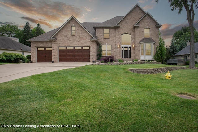 4700 Canyon Trl, Lansing, MI 48917 - traditional-style house with driveway, a lawn, brick siding, a garage, and a shingled roof