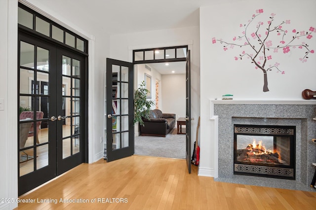 4700 Canyon Trl, Lansing, MI 48917 - foyer featuring french doors, wood finished floors, and plenty of natural light
