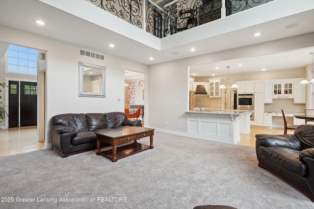 4700 Canyon Trl, Lansing, MI 48917 - living area featuring light carpet, recessed lighting, and a high ceiling